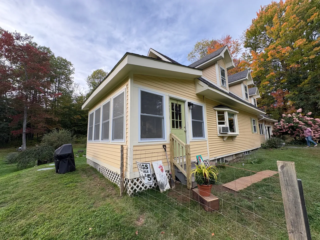 Wide view of the finished addition in fall
